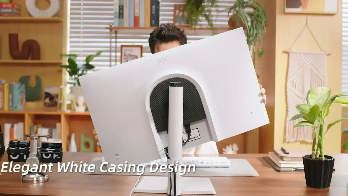 Rear view of a white monitor with a dark textured center and a vertical stand column on a wooden desk.