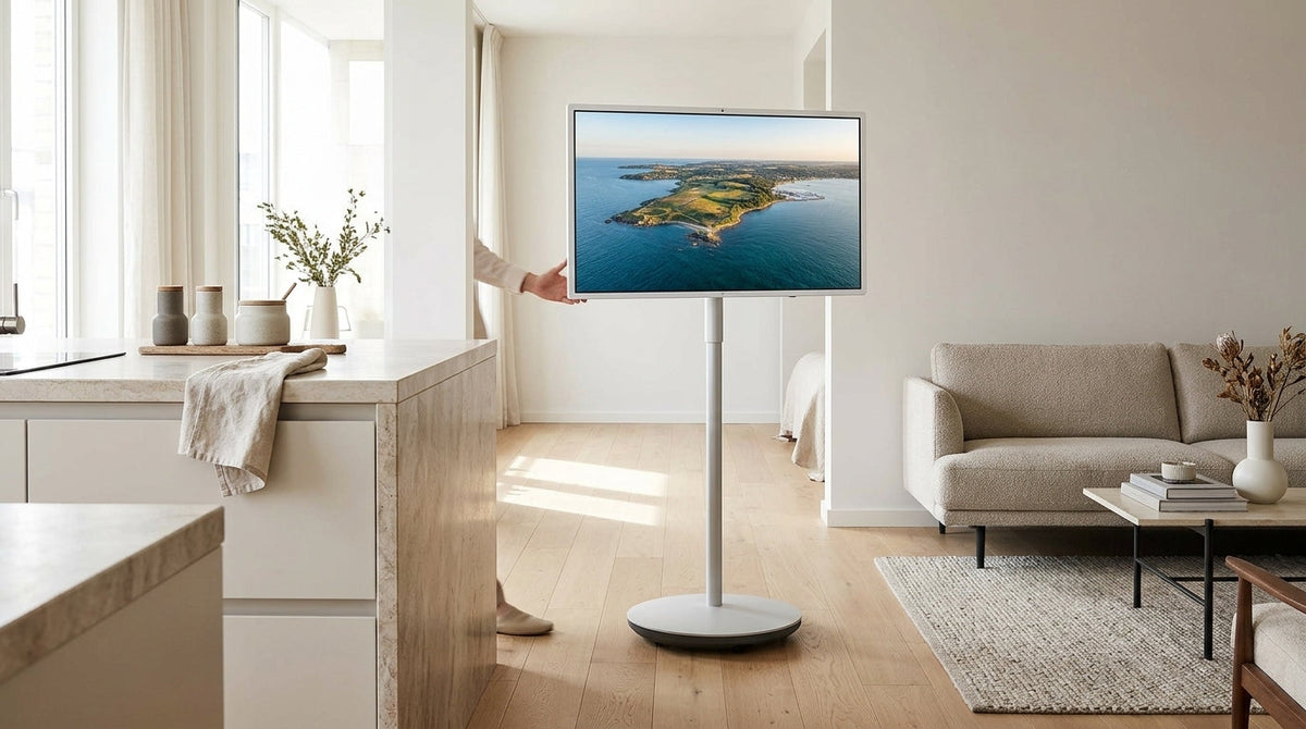 Rolling smart display on a wheeled stand in a modern apartment setting
