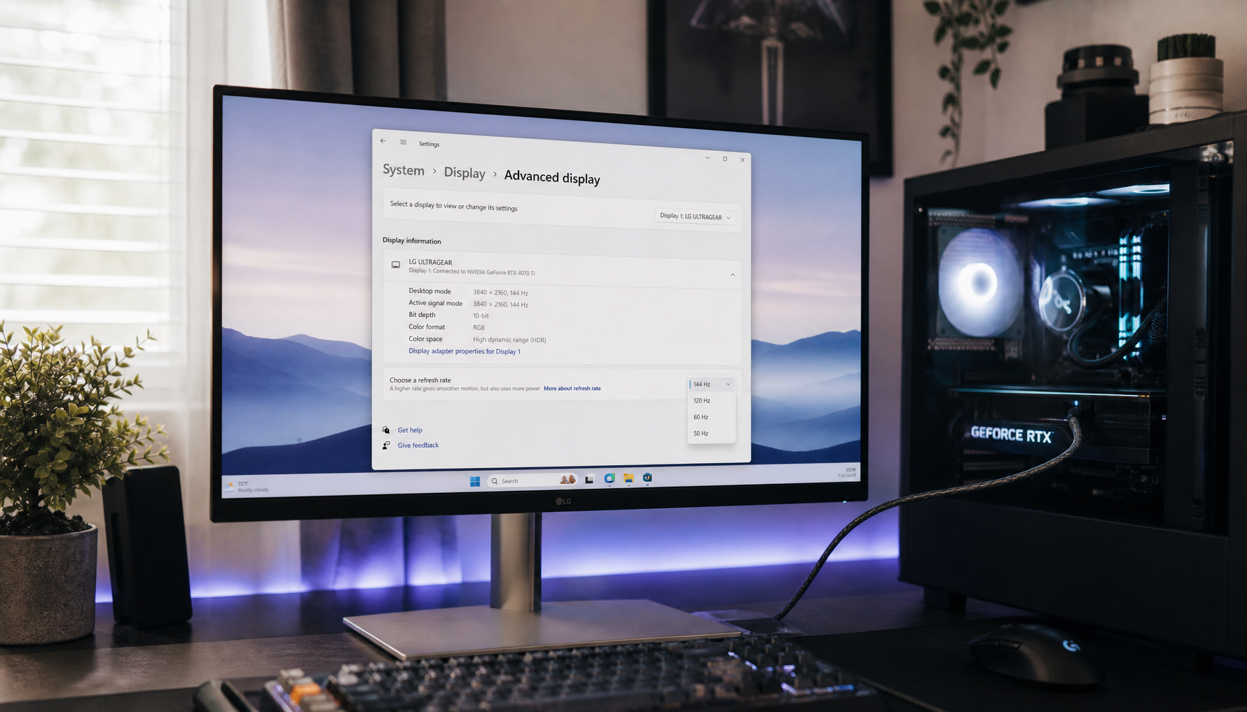 Gaming monitor showing Windows Display Settings with refresh rate options, connected via HDMI cable to a PC